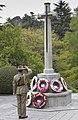 Major General David Morrison saluting at a Cross of Sacrifice at Yokohama War Cemetery, on Anzac Day 2006