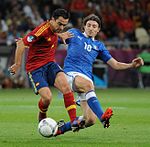 Spanish national team player Xavi and Italian national team player Riccardo Montolivo battle for a ball in the Euro 2012 final
