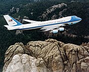 Presidential authority, past and present: Air Force One flying over Mount Rushmore