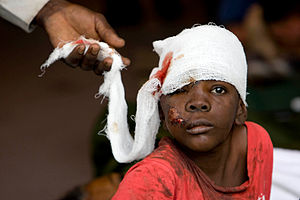 A Haitian boy receives treatment at an ad hoc ...