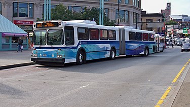 The Bx12 Select Bus Service stops in front of Fordham Plaza above Fordham's Metro-North railroad station. Bx12 5740 NF-D60HF at Fordham Plaza.JPG