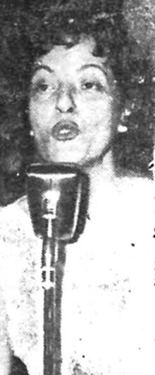 Woman standing behind a microphone