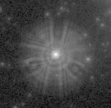 An extract from a WF/PC image shows the light from a star spread over a wide area instead of being concentrated on a few pixels. Hubble PSF with flawed optics.jpg