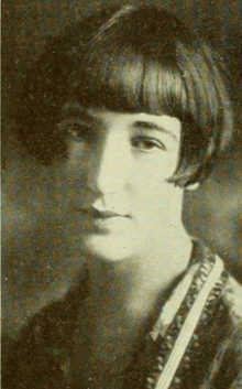 A young white woman with dark hair cut in a short bob with bangs