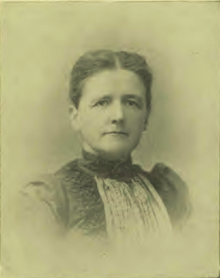 B&W portrait photo of a middle aged women with her hair in an up-do