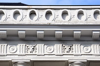 Frieze with triglyphs and metopes surmounted by an openwork attic