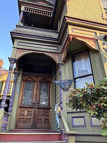 Photograph of the top of a staircase and doors into a Victorian house