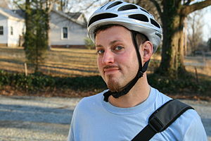 English: A man wearing a bicycle helmet in Dur...