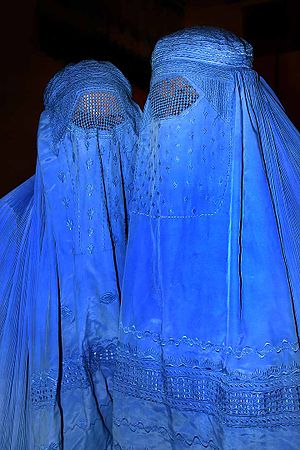 Women wearing burqas, the most concealing of a...
