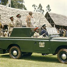 Kenya's first president, Jomo Kenyatta, opens the Eldoret Agricultural Show in 1968. COLLECTIE TROPENMUSEUM President Jomo Kenyatta staande in een landrover tijdens de opening van de Eldoret Agricultural Show TMnr 20038661.jpg