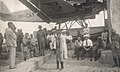 Communist civilians and rebel soldiers stand guard near the captured aircraft.