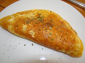 English: An omelet with ham, cheese, and a gar...