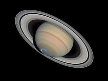 Saturn with an aurora, circular in shape, blue, located in the South Pole of Saturn.