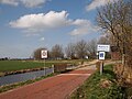 Het wapen van aangebracht onder het plaatsnaambord van Aalsum.