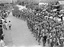 Soldiers of the Australian 2/31st Battalion passing through the town of Bandjermasin in Borneo as they took responsibility for the area from the Japanese. They are being given an enthusiastic welcome by local civilians. Australian 2-31 Bn parading through Bandjermasin Sept 1945.jpg