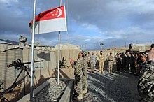 In 2007, military personnel from the Singapore Armed Forces were deployed in Afghanistan as part of a multinational coalition. Flag lowering by Singapore troops, Kiwi Base, Bamyan Province, Afghanistan - 20101027.jpg