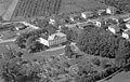 7. juli 1950, Austad gård, som var rådhus i skoger. Det røde huset ligger i Styrmoes vei 36 og det hvite huset lengst til venstre midt i bildet er Austadveien 2. Heggveien går inn til høyre foran dette huset. Harald Hårfagres gate er under bygging øverst i bildet.