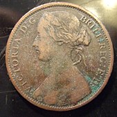 One sides of a bronze penny showing a woman with her hair in a bun