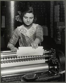 A fourteen year old Italian girl working at a paper-box factory (1913) Italian Girl (14yo) Paper Box Factory 1913.png