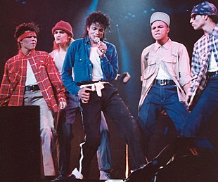 Singer Michael Jackson on stage with backing dancers