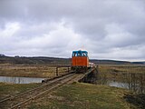 ТУ8 с гружёным составом на мосту через р. Теша