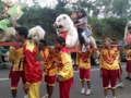 Sisingaan dance with kids riding the lion effigy.