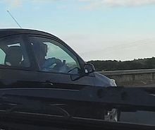 Driver texting while driving a car in the United Kingdom TEXTING WHILE DRIVING.jpg