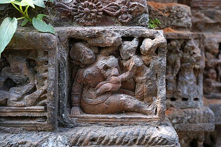 A terracotta panel depicting Putana breastfeeding Krishna in Halisahar