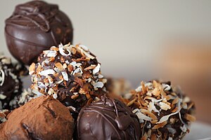 Truffles with nuts and chocolate dusting in de...