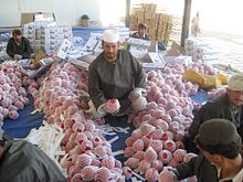 Workers processing pomegranates (anaar), for which Afghanistan is famous in Asia Afghan pomegranate processing.jpg