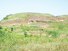Defensive wall of the ancient city of Dholavira, Gujarat 2600 BCE Dholavira gujarat.jpg