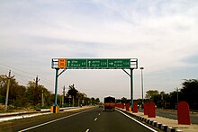 Road sign on NH11 near Ajmer, Rajasthan. This is an example of a Gantry-mounted advance direction ahead of an at-grade junction