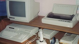 A Tandy 1000 HX with a Tandy DMP-133 dot-matrix printer.