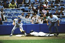 Rickey Henderson--the major leagues' all-time leader in runs and stolen bases--stealing third base in a 1988 game Baseball steal.jpg