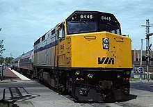 Yellow-nosed locomotive with silver coaches