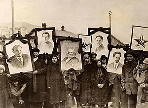 Russian peasants holding banners of Lenin (left), Marx (centre) and Trotsky (right) in early Soviet Russia. Lenin and Trotsky.jpg