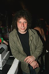 Stuart Cable standing at a bar