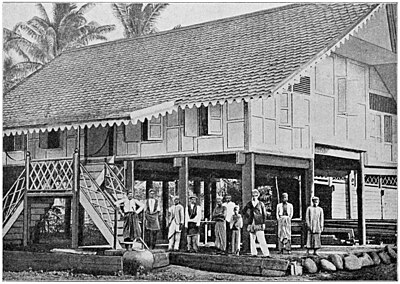 THE LATE TEUKU KALI MALIKŌN ADÉ STANDING ON THE STEPS OF THE HIS NEW HOUSE.