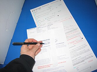 A Californian voter fills out a provisional ballot form while voting in the 2004 United States presidential election Voting in Berkley (2150673984).jpg