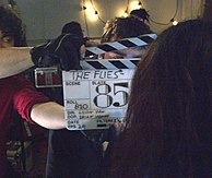 An acrylic glass clapperboard in use