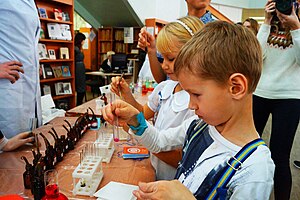 Children mix chemicals in test tubes as part of a hands-on chemistry education program in Samara, Russia. Festival of Science in Samara.jpg