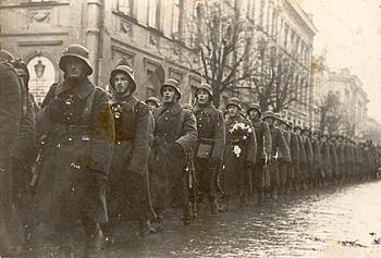 Lithuanian soldiers marching in Lithuanian cap...