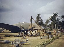 RAF fitters and local workers change an aircraft engine at a West African base, probably Yundum, 1943. Lockheed Hudson - Royal Air Force in West Africa, April 1943 TR905.jpg