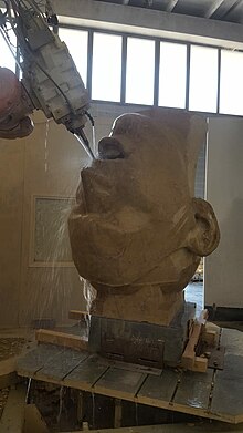 A large Stone head is cut from marble using 5-axis cnc milling