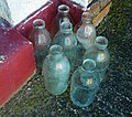 Seven modern Dairy Crest milk bottles.