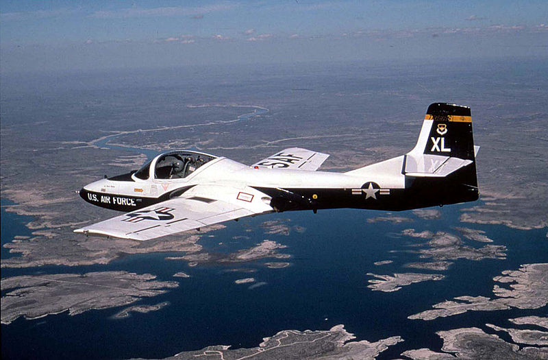 A T-37 Tweet from the 85th Flying Training Squadron, Laughlin Air Force Base, Texas, flies over Amistad Reservoir during a training mission.