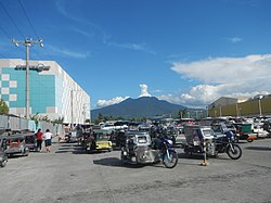 View of Mount Makiling, with SM City Calamba and Walter Mart Calamba on either side of the tricycle terminal