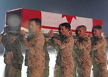 Canadian Forces personnel carry the coffin of a deceased comrade onto an aircraft at Kandahar Air Field, 1 February 2009 Air Field to salute.jpg