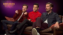 Mazzello (left) with Rami Malek and Gwilym Lee promoting Bohemian Rhapsody in 2018. Bohemian Rhapsody cast on MTV Movies.jpg