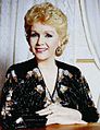 Q263696 Debbie Reynolds in 1986 (Foto: Allan Warren) geboren op 1 april 1932